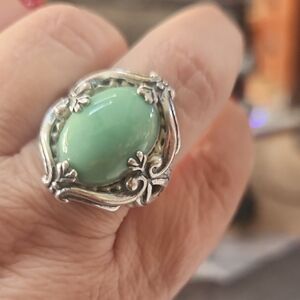 This is a Carolyn Pollack sterling silver ring with an oval green stone